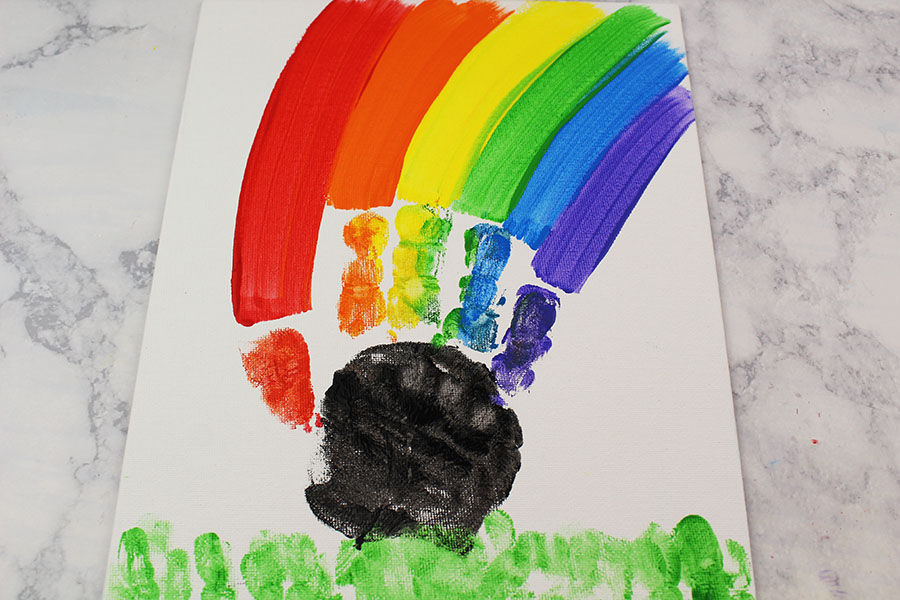 This cute and colorful handprint rainbow craft is perfect for a rainy day activity or as a fun St. Patrick's Day craft! 