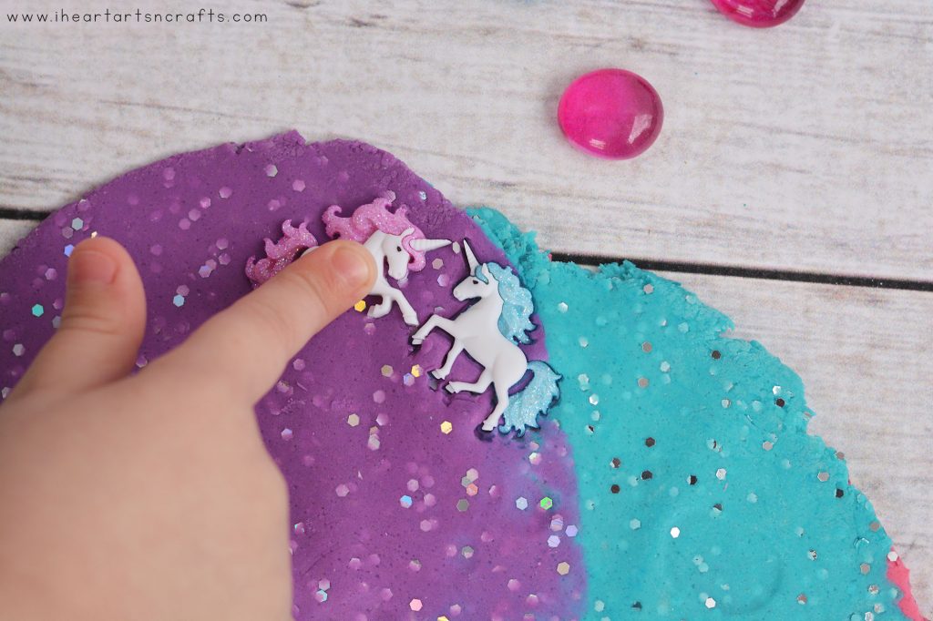Make your own Homemade Unicorn Playdough! This colorful and glittery no cook playdough is the softest and last for months!
